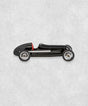 Vintage racing silberfeil car  model inspired by classic Grand Prix racers and Silver Arrow legends, featuring a sleek black race car body with a striking red seat. A collectible car model for motorsport and classic car enthusiasts. Viewed from  the left side.