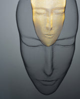 Close-up of Arturo Álvarez illuminated mesh mask wall sculpture – handcrafted metallic mesh revealing intricate texture, volume and light