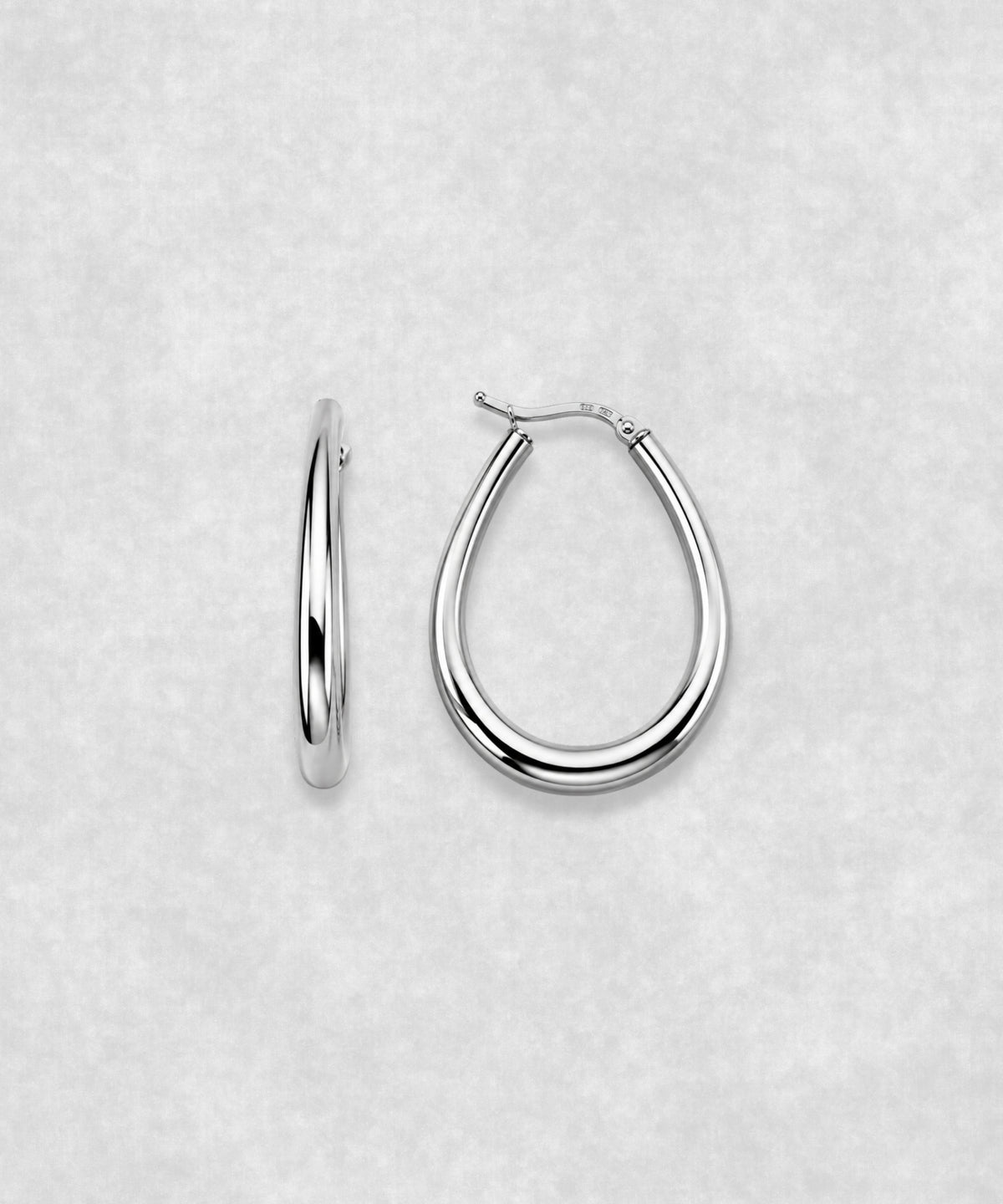 Front and side view of oval hoop earrings in 925 sterling silver – polished sculptural silver earrings with contemporary minimalist design