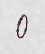 White gold-coated bracelet featuring a medium centerpiece set with 29 diamonds and a flexible bordeaux rubber band.